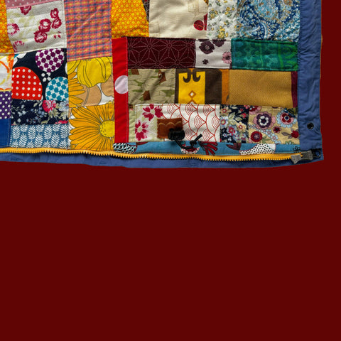 close up of Patagonia jacket opened to show vibrant quilted lining — upcycled with bold colourful repurposed fabric patchwork by boroboro