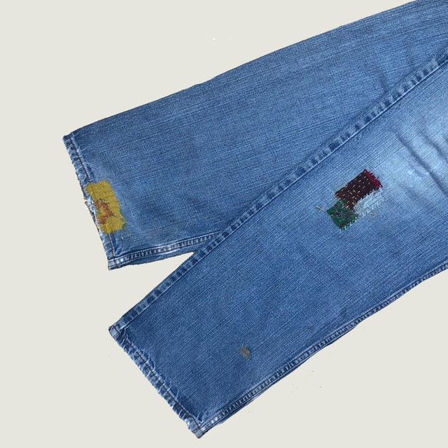 Artistically mended denim using threads and fabric