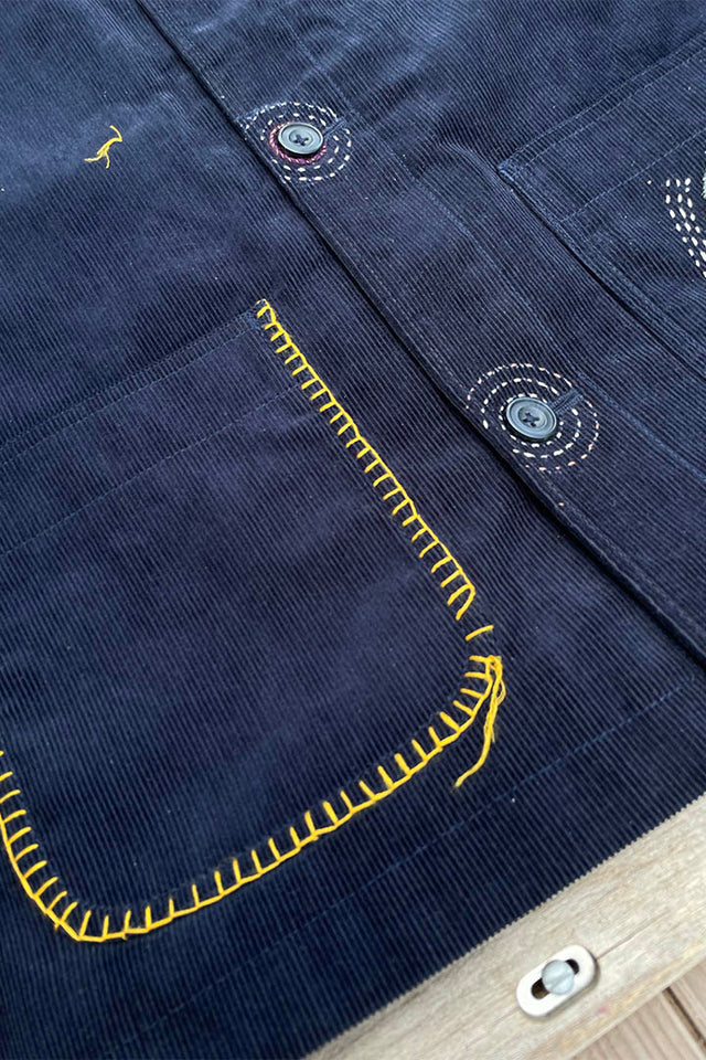 yellow blanket stitching around blue cord pocket