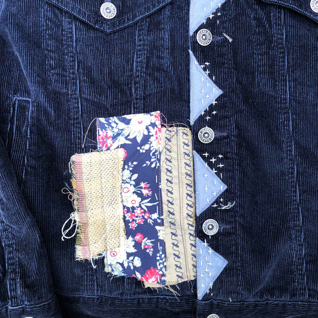 front of dark blue corduroy jacket with patches and sashiko stitching