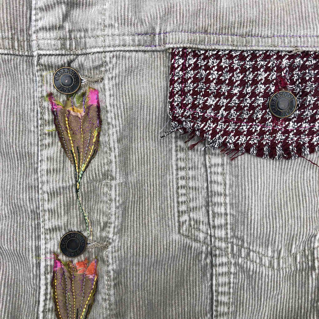 Embroidery detail of flowers on cord jacket